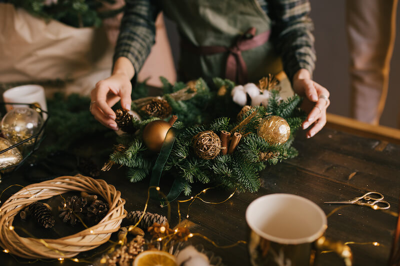 Woman Making a DIY Christmas Wreath