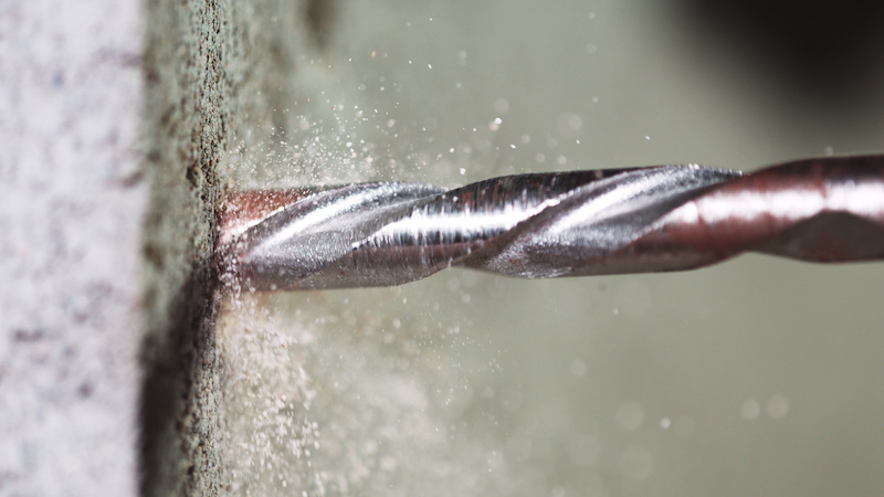 Close-Up of Drill Bit Boring Into Concrete