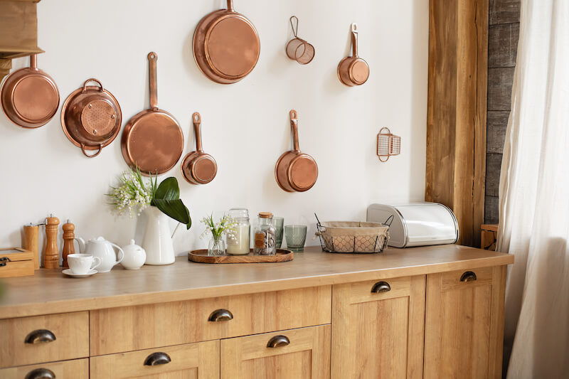 Copper Pots Hung on Wall in Kitchen as Wall Art